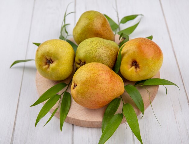 Front view of peaches on cutting board and wooden surface