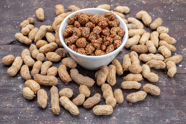 Front view peanuts and nuts sweet and sticky on grey nut peanut sweet snack photo