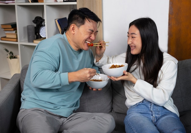 Front view people eating asian food