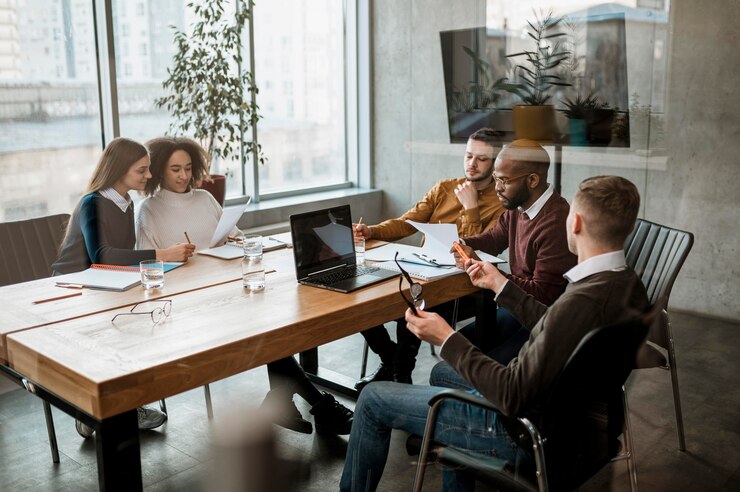 Free Photo front view of people having a meeting in the office