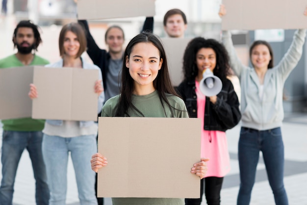 Front view people holding copy space cardboards