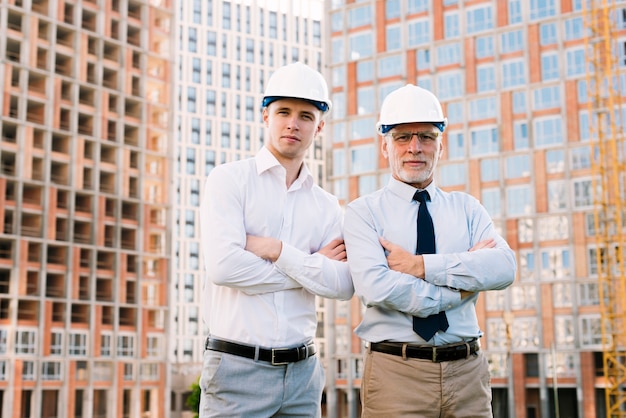 Front view people with helmets and crossed arms