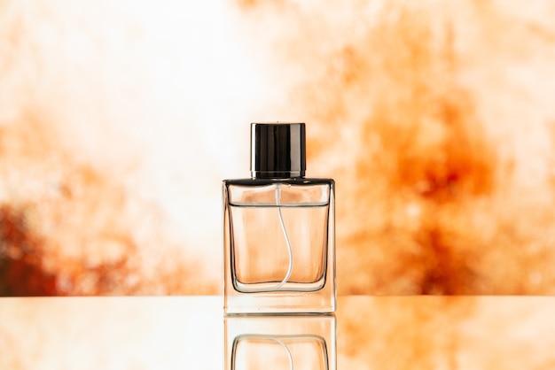 Front view perfume bottle on biege blurred background