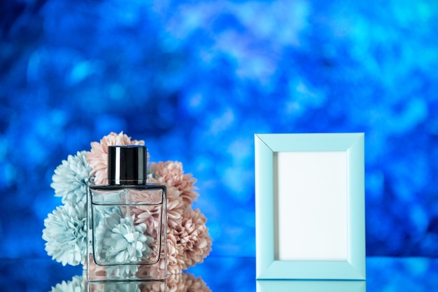 Front view perfume bottle blue picture frame flowers on light blue background