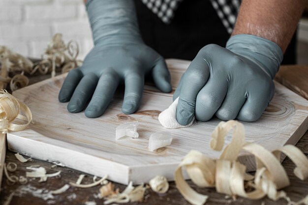 Front view person crafting in wood close-up