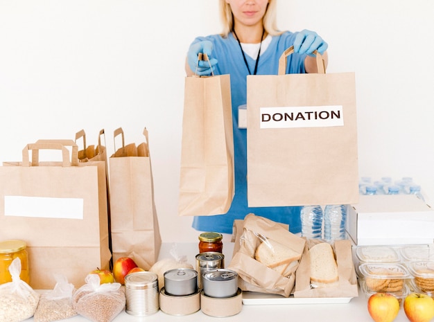 Front view of person handing out donation bags