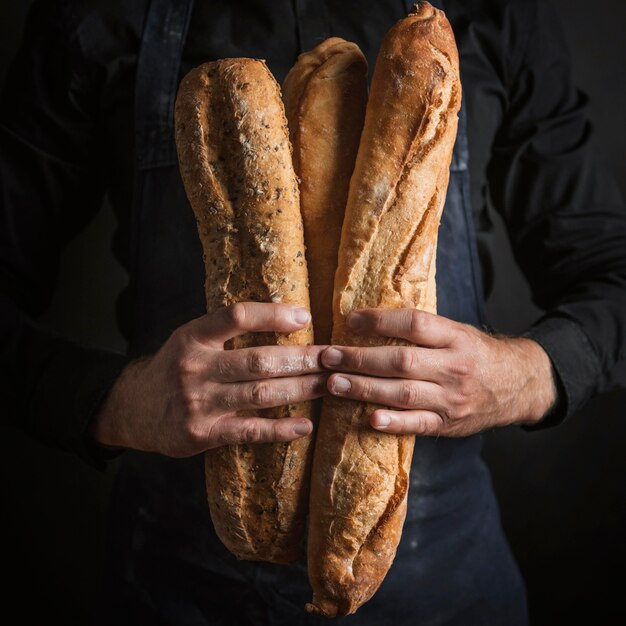 Front view person holding bread