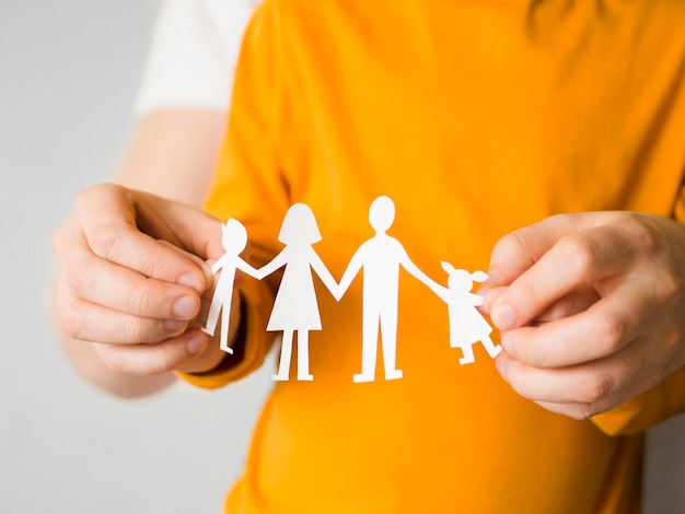 Front view person holding family paper