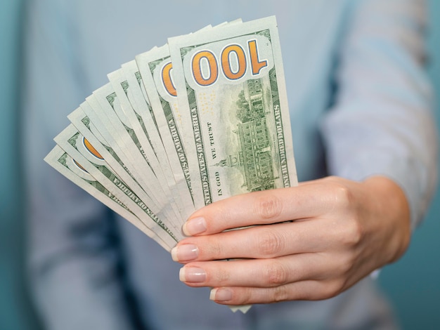 Free Photo front view of person holding money