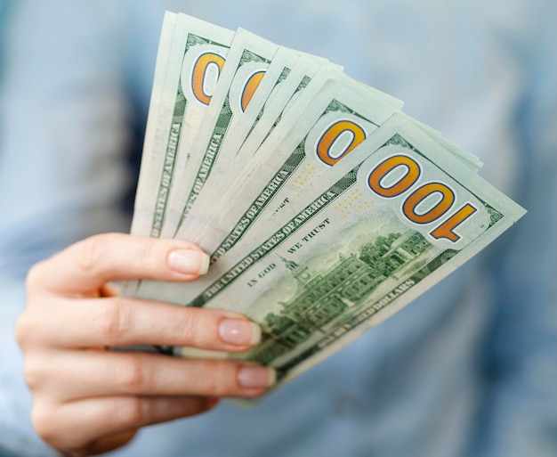 Free Photo front view of person holding money