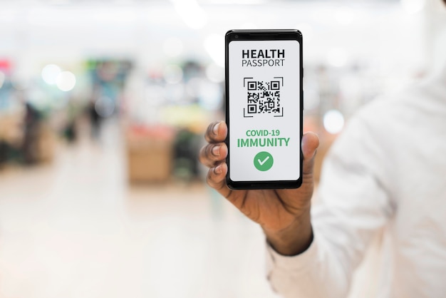 Front view of person holding virtual health passport on smartphone