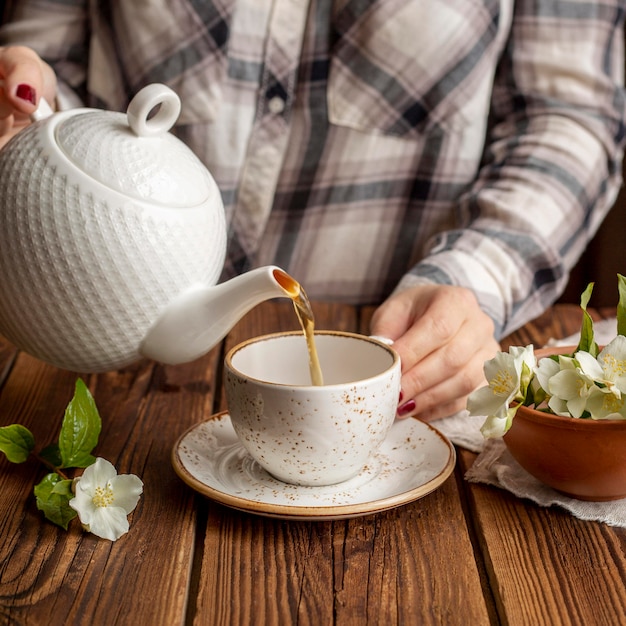 Front view of a person pouring tea concept