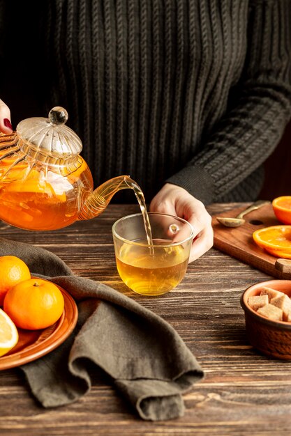 Front view of person pouring tea concept