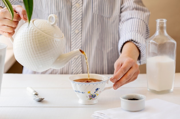 Front view of person preparing milk tea