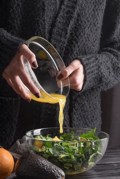 Free photo front view person preparing tasty salad