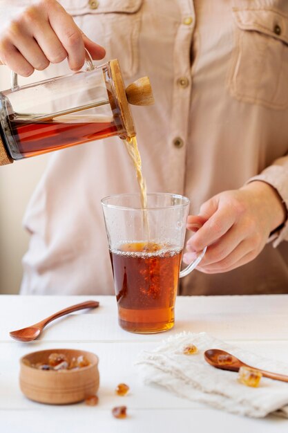 Front view of person preparing tea