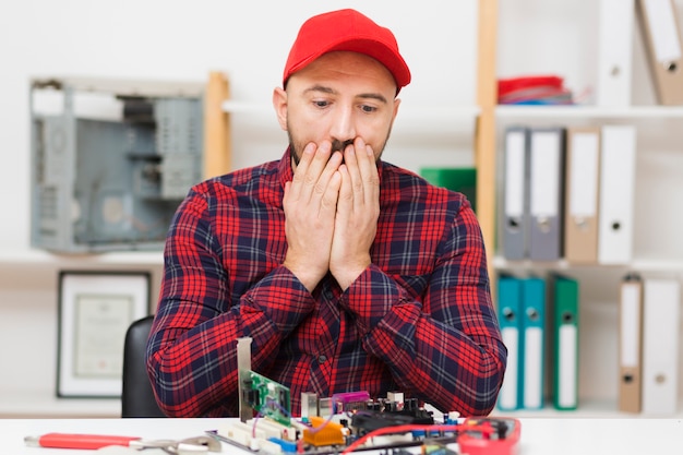 Free photo front view person repairing a motherboard