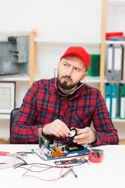 Free photo front view person repairing a motherboard