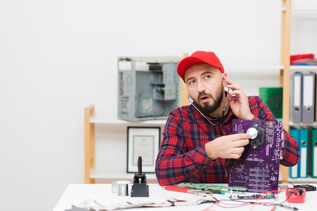 Front view person repairing a motherboard