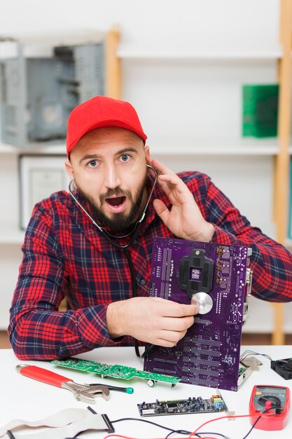 Front view person repairing a motherboard