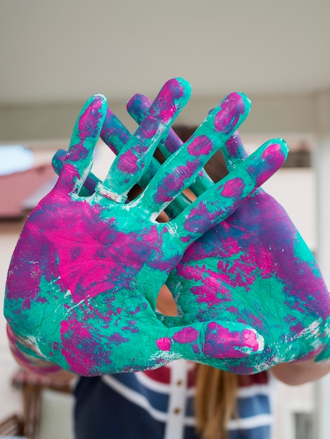 Front view of person showing painted hands