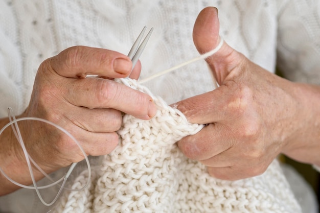 Front view of person using yarn to crochet