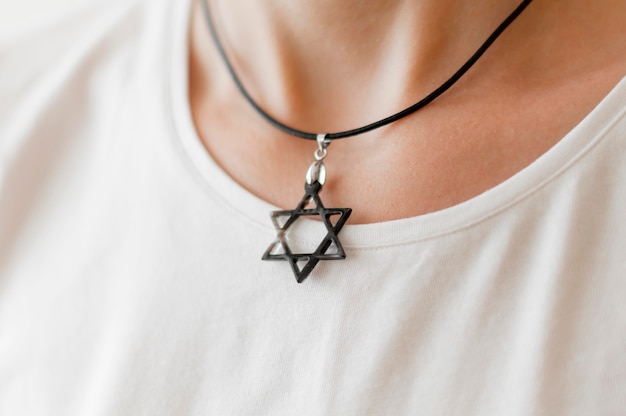 Front view of person wearing david's star pendant