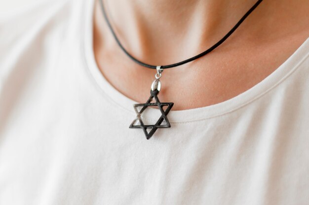 Front view of person wearing david's star pendant