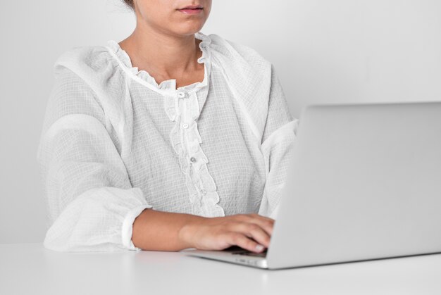 Front view person working on a laptop