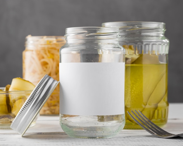 Free photo front view of pickled vegetables in clear jars