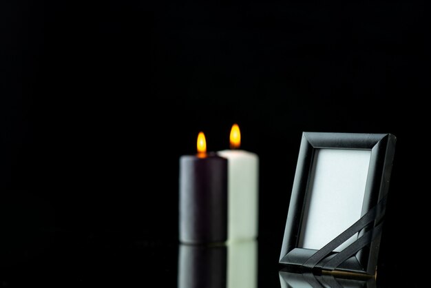 Front view of picture frame with candles on black