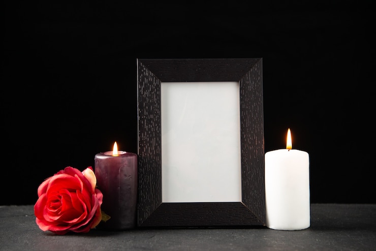 Free Photo front view of picture frame with candles on black