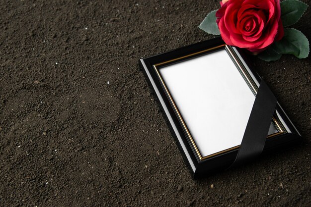 Front view of picture frame with red flower on black