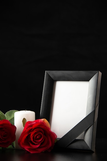 Free photo front view of picture frame with red flowers on black