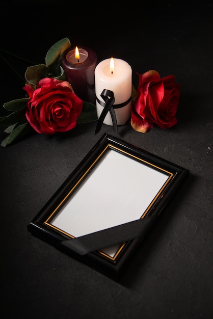 Free photo front view picture frame with red flowers on dark surface