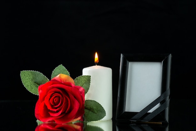 Front view of picture frame with red rose on black