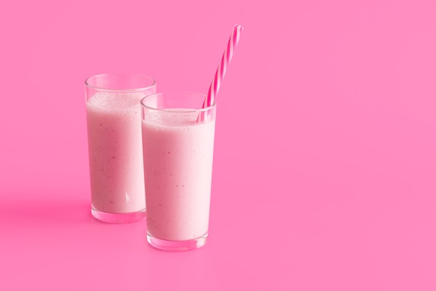Front view pink smoothie glasses with straw