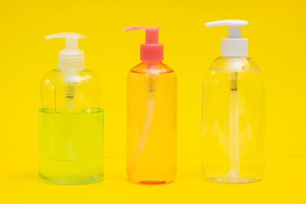 Front view of plastic bottles with hand sanitizer and liquid soap