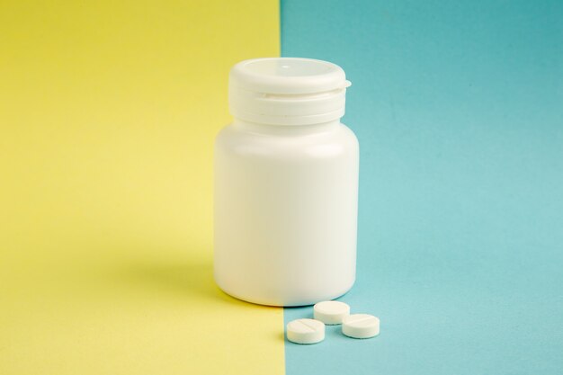 front view plastic can with pills on yellow-blue background