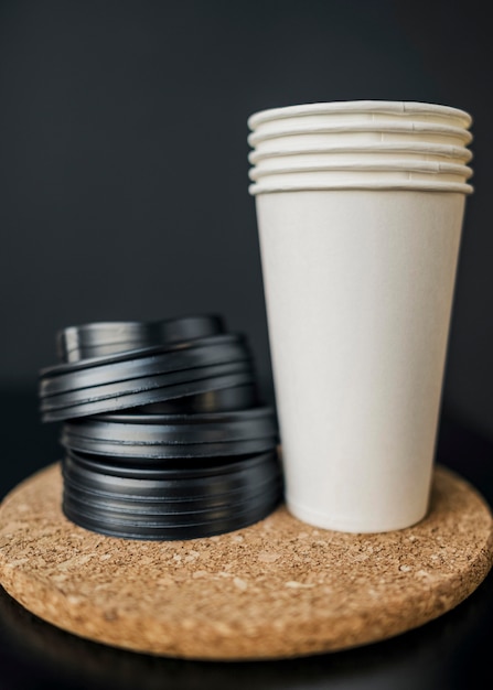 Front view of plastic coffee cups with lids