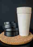 Free photo front view of plastic coffee cups with lids