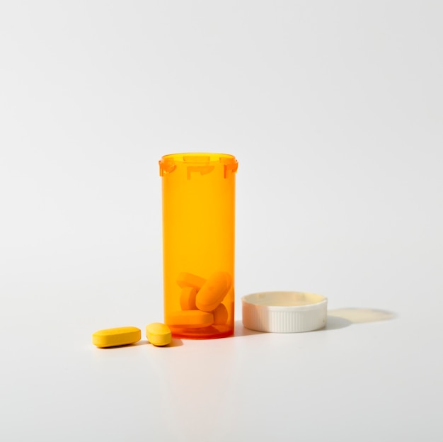 Front view of plastic container with pills