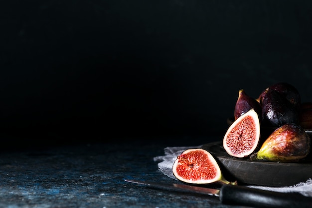 Front view of plate with bunch of autumn figs and copy space