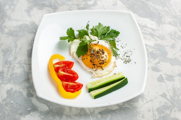 Front view plate with food vegetables and greens on light-white desk