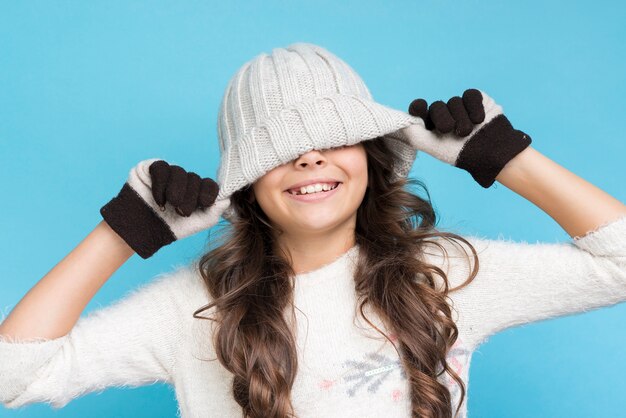 Front view playful girl wearing winter clothing