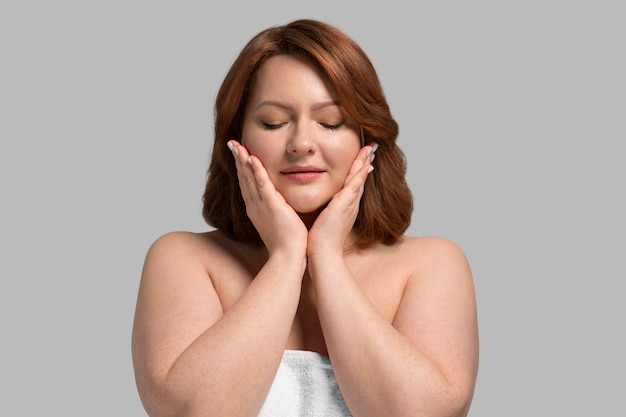 Front view plus size model posing in studio