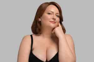 Free photo front view plus size model posing in studio