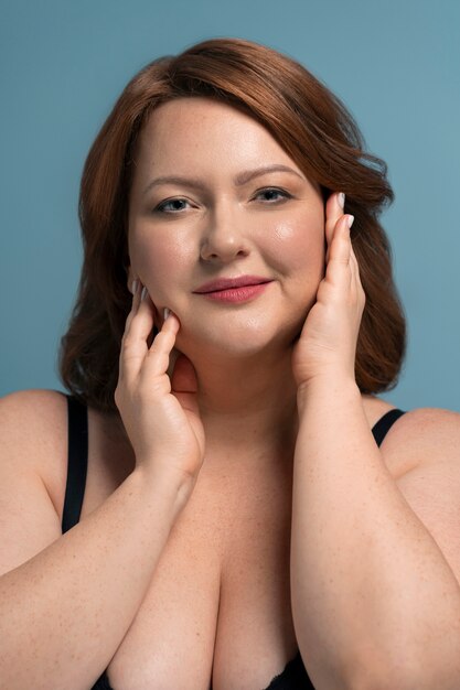 Front view plus size model posing in studio