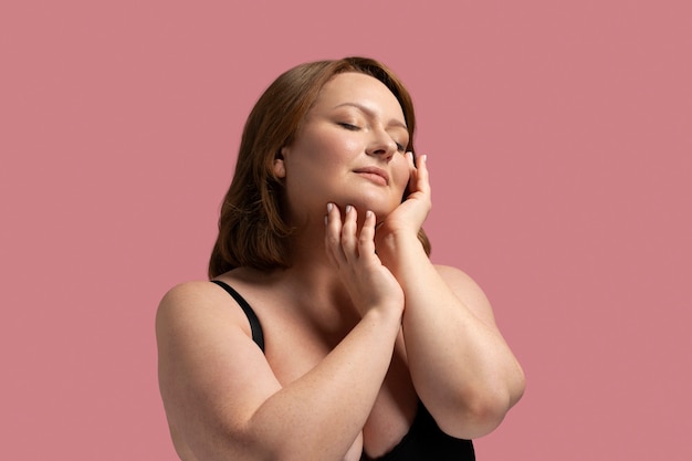 Front view plus size model posing in studio