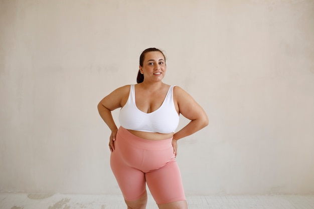 Free photo front view plus size woman posing in studio